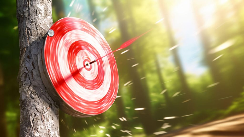 An image of a target on a tree stump with an arrow hitting the middle of the bullseye due to perfect aiming of the bow and arrow